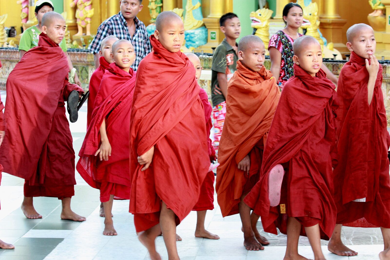 Young novice monks in red robes at Shwedagon Pagoda, Yangon